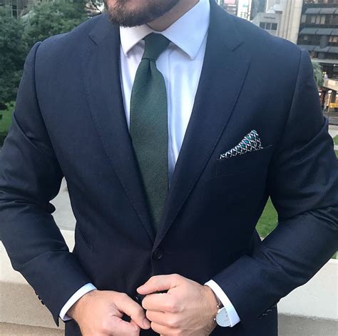 navy suit dark green tie.